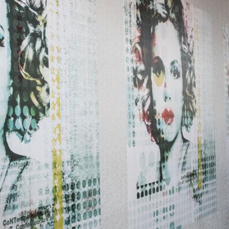 woman installing three woman's face vinyl wall graphics 
